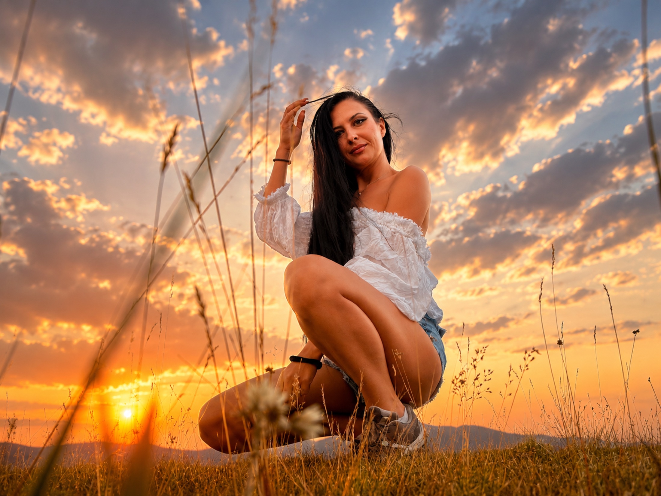 Cinematic portrait of Alishya in a field at sunset